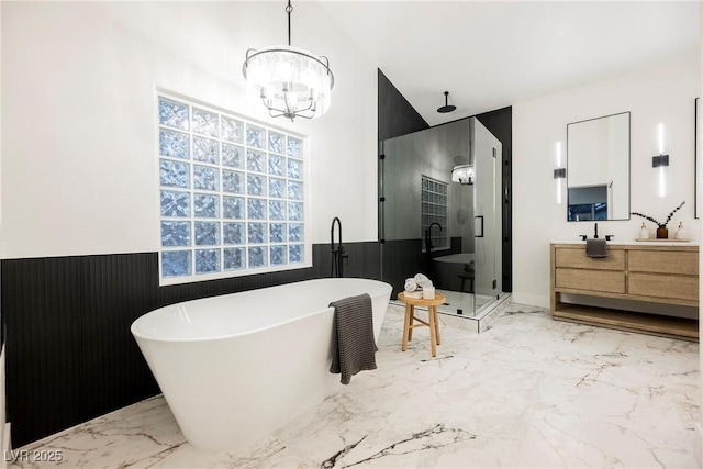 bathroom with plus walk in shower, vanity, and a chandelier