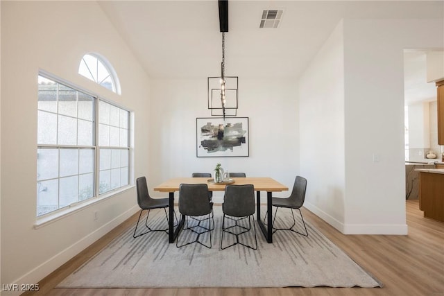 dining area with plenty of natural light and light hardwood / wood-style flooring