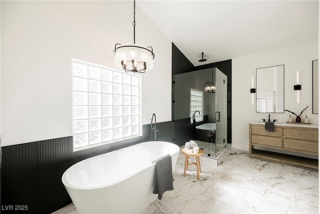 bathroom with a healthy amount of sunlight, vanity, a chandelier, and separate shower and tub