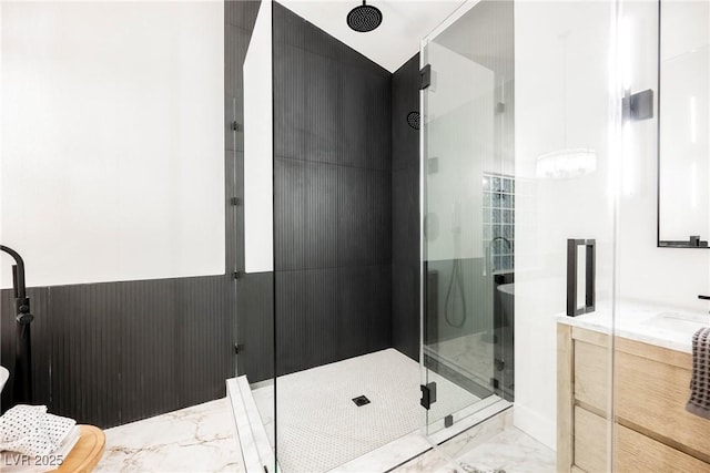 bathroom featuring vanity and a shower with door