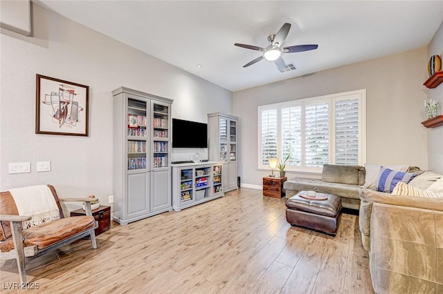 living room featuring light hardwood / wood-style flooring and ceiling fan