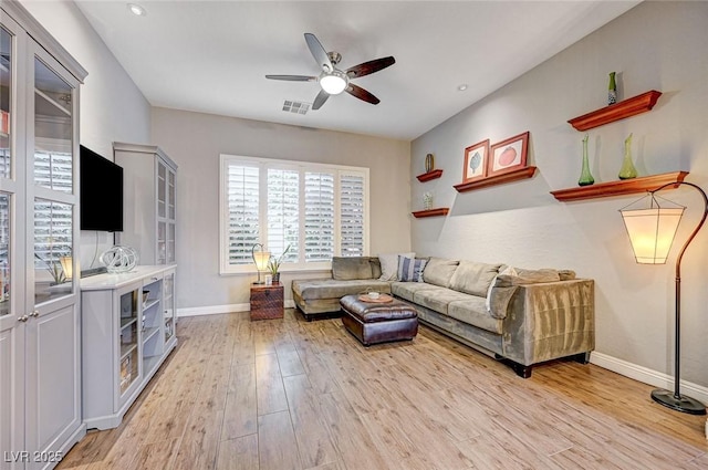 living room featuring light hardwood / wood-style floors and ceiling fan