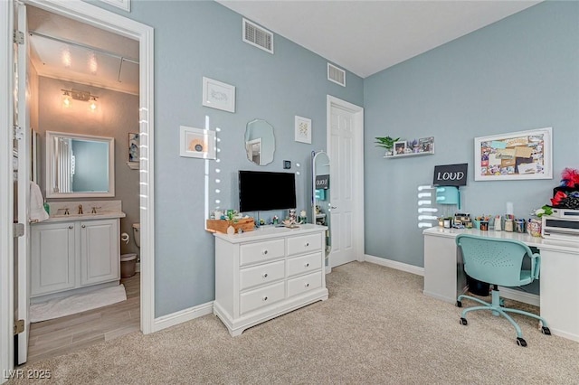 office area with sink and light colored carpet