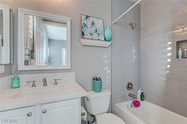 full bathroom with toilet, vanity, and tiled shower / bath