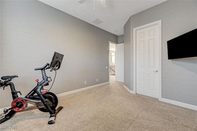 workout area featuring ceiling fan and light carpet