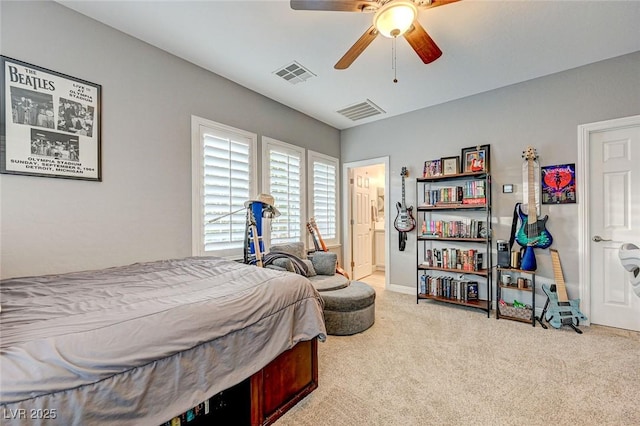 carpeted bedroom with ceiling fan and ensuite bathroom