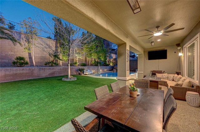 exterior space with outdoor lounge area, ceiling fan, and a lawn