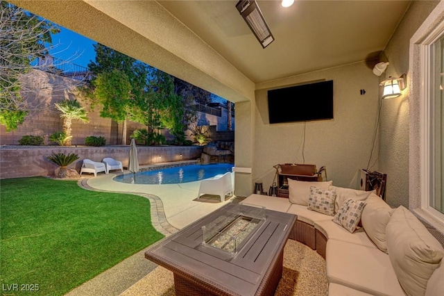 view of pool with a patio, a yard, and an outdoor living space with a fire pit