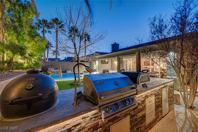 view of patio / terrace with area for grilling and a swimming pool