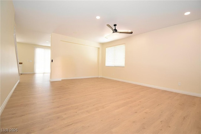 unfurnished room featuring ceiling fan, light hardwood / wood-style flooring, and a wealth of natural light