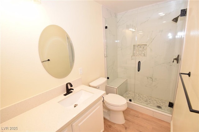 bathroom featuring vanity, hardwood / wood-style floors, toilet, and an enclosed shower