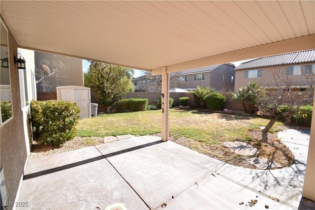 view of patio featuring a storage shed