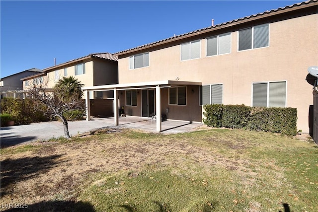 back of house featuring a yard and a patio area