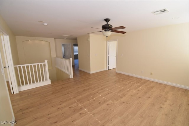 empty room with light hardwood / wood-style flooring and ceiling fan