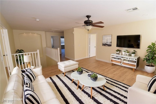 living room with ceiling fan and light hardwood / wood-style floors