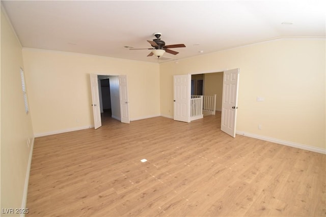 spare room featuring vaulted ceiling, ceiling fan, and light hardwood / wood-style flooring