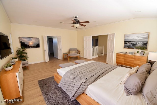 bedroom featuring ceiling fan, vaulted ceiling, and light wood-type flooring