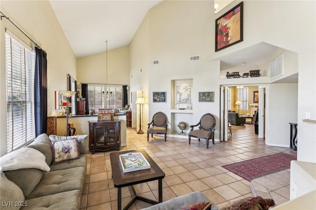 tiled living room with a chandelier and high vaulted ceiling