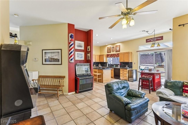 living room with sink, light tile patterned floors, and ceiling fan