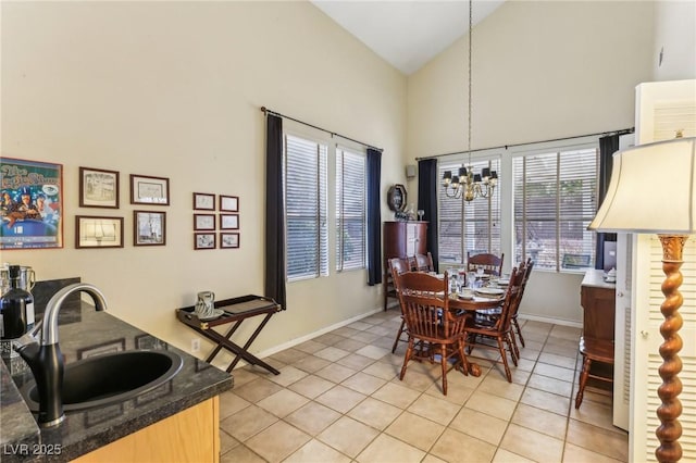 tiled dining area with an inviting chandelier, high vaulted ceiling, and sink