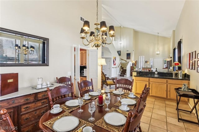 dining space with light tile patterned flooring, high vaulted ceiling, and a notable chandelier