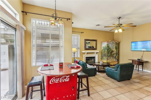 dining area featuring light tile patterned floors, plenty of natural light, and ceiling fan