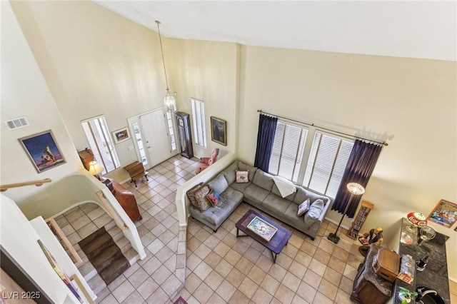 tiled living room featuring high vaulted ceiling