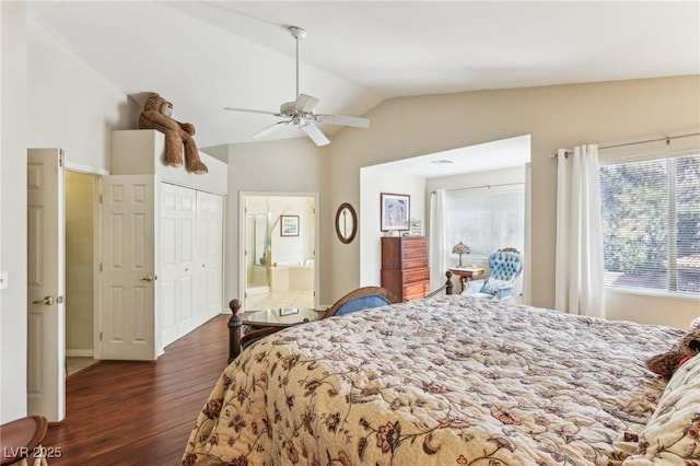 bedroom featuring dark wood-type flooring, vaulted ceiling, ceiling fan, and ensuite bathroom