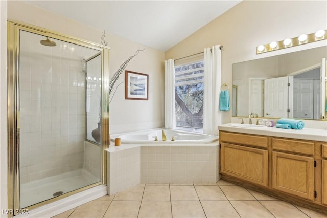 bathroom featuring vanity, lofted ceiling, shower with separate bathtub, and tile patterned floors