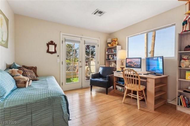 bedroom with access to exterior, light hardwood / wood-style flooring, and french doors