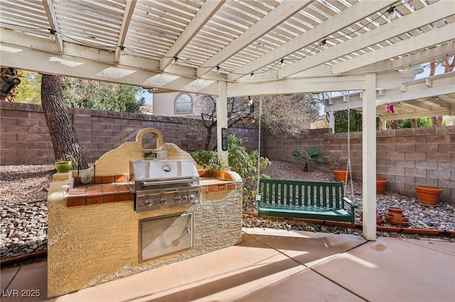 view of patio featuring area for grilling and a pergola