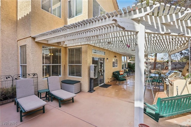 view of patio featuring a grill and a pergola