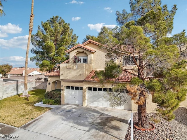 mediterranean / spanish house with a garage and a front yard