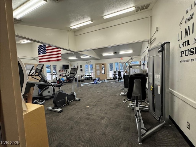 exercise room featuring dark carpet