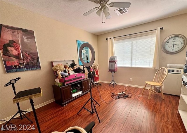 exercise room with hardwood / wood-style flooring and ceiling fan