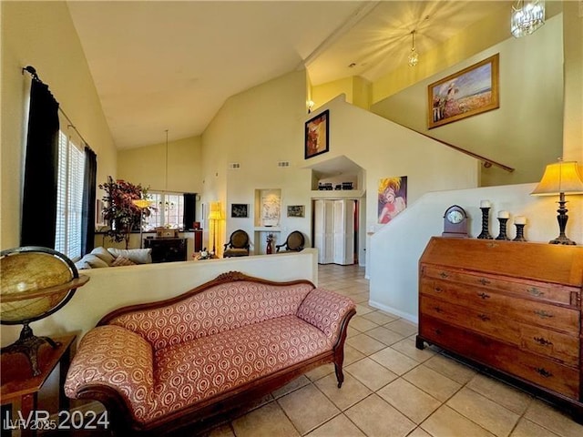 interior space featuring an inviting chandelier, high vaulted ceiling, and light tile patterned floors