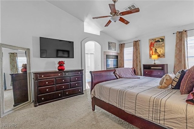 carpeted bedroom with multiple windows, vaulted ceiling, and ceiling fan