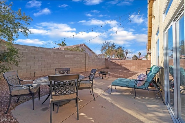 view of patio / terrace featuring an outdoor fire pit