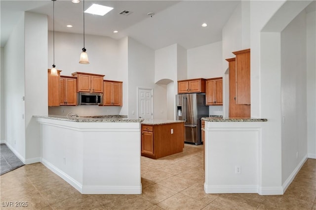 kitchen with a kitchen island, decorative light fixtures, kitchen peninsula, stainless steel appliances, and light stone countertops