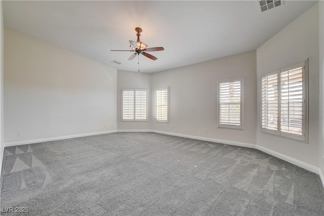 carpeted spare room featuring ceiling fan