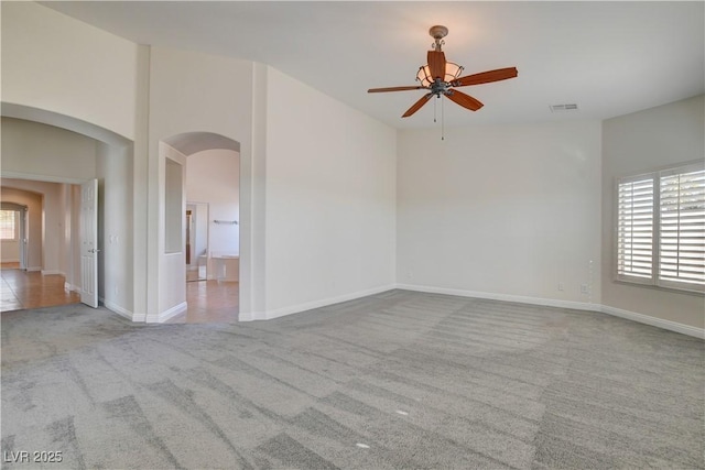 empty room with light colored carpet and ceiling fan