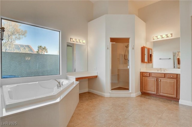 bathroom featuring vanity, tile patterned floors, plus walk in shower, and a high ceiling