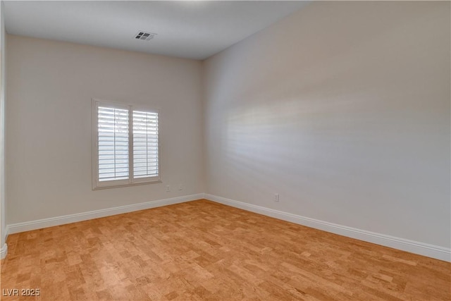 spare room with light hardwood / wood-style floors