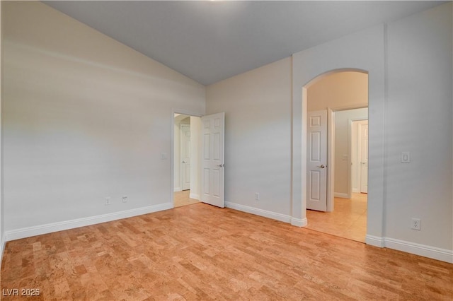 spare room featuring lofted ceiling