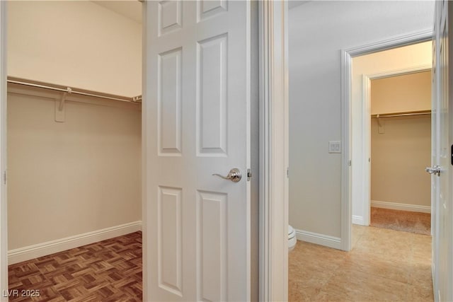 spacious closet featuring light parquet flooring