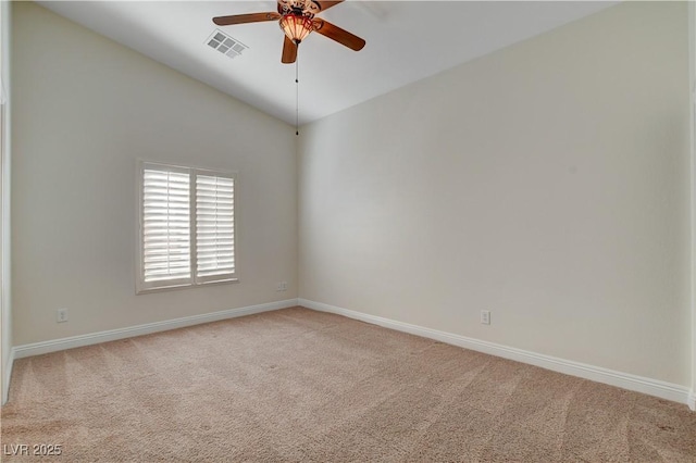 empty room featuring lofted ceiling, light carpet, and ceiling fan