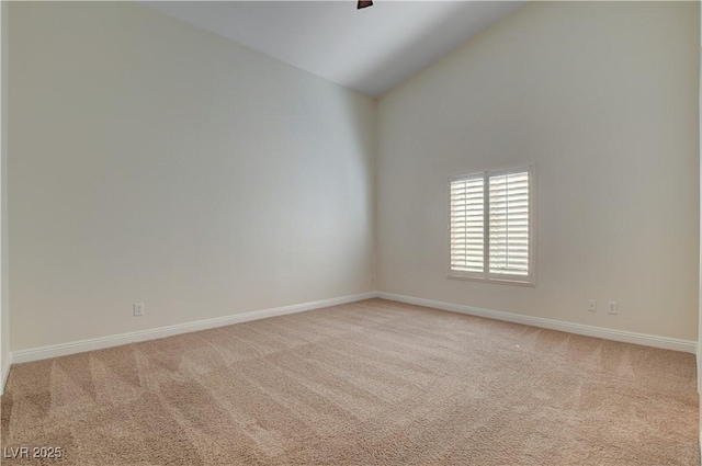 carpeted spare room with high vaulted ceiling