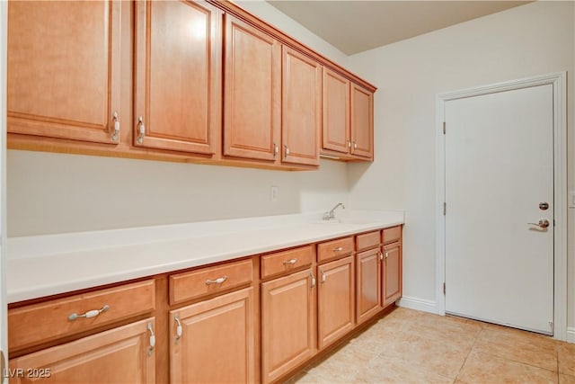 kitchen featuring sink and light tile patterned floors