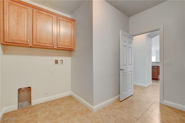 washroom featuring cabinets, light tile patterned flooring, and washer hookup