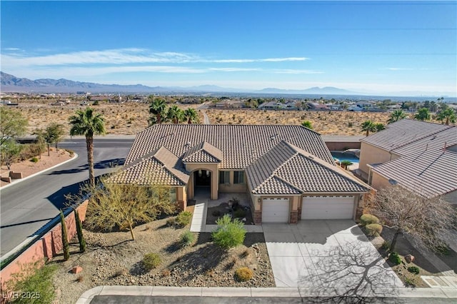 birds eye view of property with a mountain view